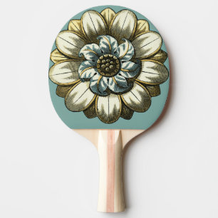 Verziertes Blumenmedaillon auf hellblauem Tischtennis Schläger