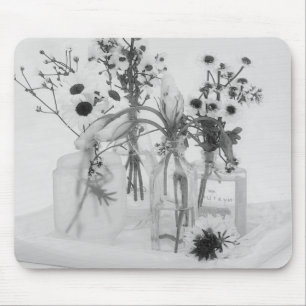 Vier Flaschen und weiße Blume Mousepad