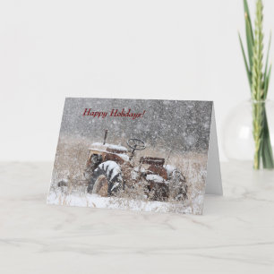 Vieux tracteur dans la carte de vacances neige