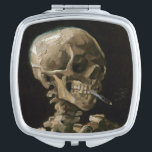 Vincent van Gogh Art Taschenspiegel<br><div class="desc">Vincent van Gogh (Niederländisch, 1853 - 1890) Schädel eines Skeletts mit brennender Zigarette, 1885-86, Öl auf Leinwand Ungerahmt: 32 cm × 24, 5 cm (13 in × 9, 6 in) Früharbeit von Vincent van Gogh. Dieses kleine Gemälde ist Teil der ständigen Sammlung des Van Gogh Museums in Amsterdam. Es wurde...</div>