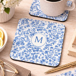 Vintage Blue Chinoiserie Monogram  Getränkeuntersetzer<br><div class="desc">This coaster features an elegant, timeless floral design rendered in rich shades of blue against a soft, light background. Delicate botanical elements—blossoms, leaves, and winding stems—flow organically across the surface, creating a balanced composition. The artwork has a hand-illustrated, slightly textured look reminiscent of vintage toile or traditional botanical prints. Varying...</div>