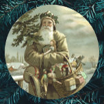 Vintage Christmas, Victorian Santa Claus with Toys Runder Aufkleber<br><div class="desc">Vintage illustration Christmas holiday design featuring a Victorian Santa Claus walking through the snow leaving footprints. He is carrying a Christmas tree and a basket of toys on a cloudy evening with the moon shining through the clouds. Originally a Scandinavian postcard with the text: God Jul or Merry Christmas.</div>