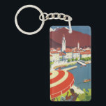 Vintage Reise die Schweiz Schlüsselanhänger<br><div class="desc">Vintage Grafik einer klassischen Seeseitenszene bei Lago Maggiore in Tessin,  die Schweiz mit einer Zahl saß unter einem großen roten und weißen Sonneregenschirm im Vordergrund.</div>