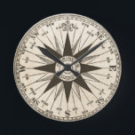 Vintage Rose Runde Wanduhr<br><div class="desc">Eine Vintage Kompass-Rose in Sepia auf einem Pergament getönt antiquierten Hintergrund. Das Zentrum liest "Mariner-Kompass". Zählen Sie die Zeit,  während die Hände über die Richtungen des Kompasses gehen. Nord ist um 12:00 Uhr. Ein fantastisches Geschenk für einen Agent,  Schiffskapitän oder Weltreisenden.</div>
