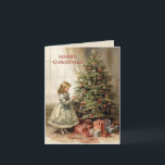 Vintage Weihnachtsbaumgeschenke Feiertagskarte<br><div class="desc">Faltete Urlaubskarte mit einem Vintagen Bild eines Mädchens, das einen Weihnachtsbaum mit eingewickelten Geschenken unter sich schmückt. Text sagt, "Frohe Weihnachten", aber ist für Ihre eigenen Gruß anpassbar. Personalisiert auf der Rückseite mit Ihrer Nachricht und Ihrem Namen. Kontaktieren Sie mich für Hilfe bei Ihrer Anpassung oder um zusätzliche Matching oder...</div>