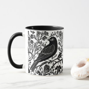 Vogel auf einer Zweigstelle mit Blume in Schwarz u Tasse
