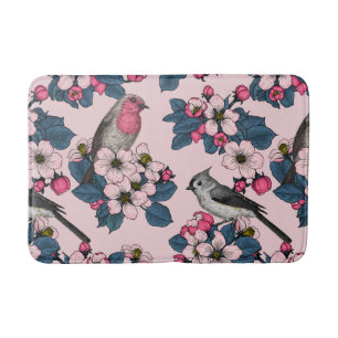 Vögel und Blüten auf rosa Badematte