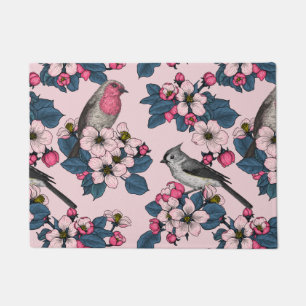 Vögel und Blüten auf rosa Fußmatte