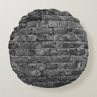 waagerechter Teil der Wand aus schwarz gestrichene Rundes Kissen