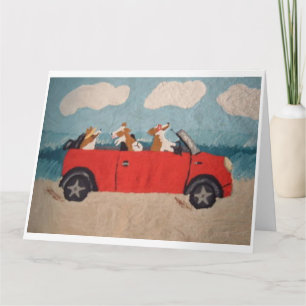Walisische Corgis in einem roten Cabrio am Strand Karte