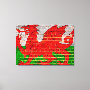 Walisische Flagge an einer Ziegelmauer Leinwanddruck