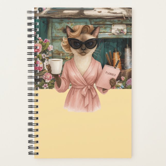 Weibliche Katze hält Terminkalender  Planer (Vorderseite)