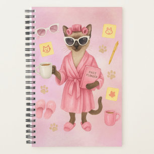 Weibliche Katze hält Terminkalender Planer