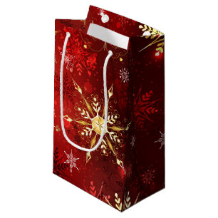 Weihnachten Goldene Schneeflocken im roten Hinterg Kleine Geschenktüte