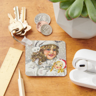 Weihnachtliche viktorianische Mädchen mit Puppe im Schlüsselanhänger