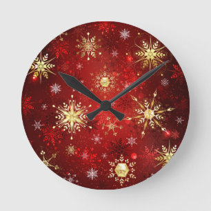 Weihnachts-Goldschneeflocken auf rotem Hintergrund Runde Wanduhr