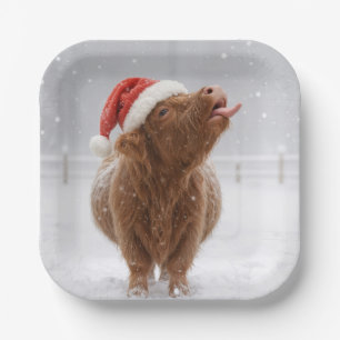 Weihnachts-Hochlandkuh fängt Schneeflocken Pappteller