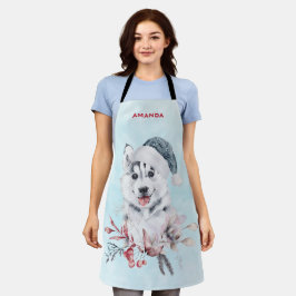 Weihnachts-Husky-Hund in einer Weihnachtsmannmütze Schürze