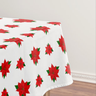 Weihnachts-Poinsettia-Blume auf White Tableclout Tischdecke