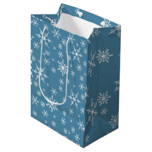 Weihnachts-Schneeflocke auf blau Mittlere Geschenktüte
