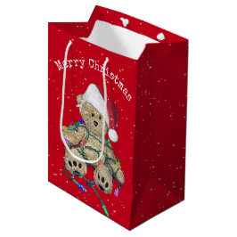 Weihnachts-Teddy-Bär in getrübten Lichtern Mittlere Geschenktüte