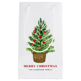 Weihnachtsbaum auf einem Wicker Korb Frohe Weihnac Kleine Geschenktüte