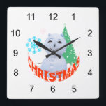 Weihnachtsbaum und Schneemann Quadratische Wanduhr<br><div class="desc">Foto eines Schneemanns,  zeichnend von einem Weihnachtsbaum und zwei Schneeflocken,  Rottext Weihnachten. Drucke,  T - Shirt und Geschenke für Spaß und gute Laune. Weihnachten und Neujahr genießen</div>