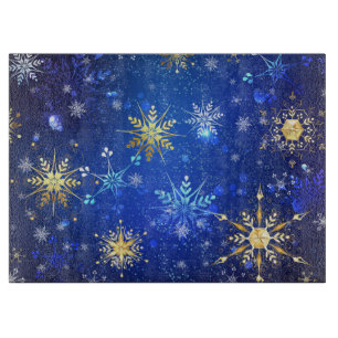Weihnachtsblauer Hintergrund mit goldenen Schneefl Schneidebrett