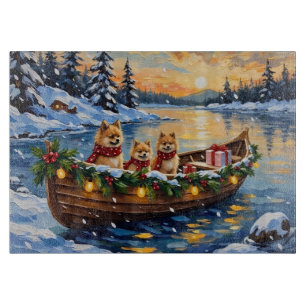 Weihnachtsboot-Feier mit Pomeranian Schneidebrett