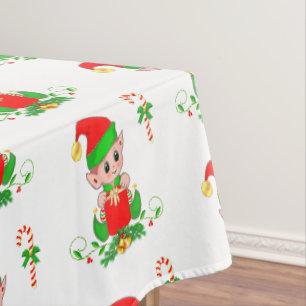 Weihnachtself und Zuckerstange auf weißer Tischdec Tischdecke