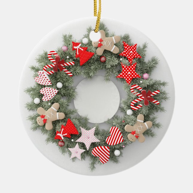Weihnachtsfeier Keramik Ornament (A festive Christmas ornament features a circular wreath made of green pine needles.)
