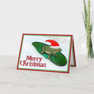 Weihnachtsfrosch beim Durch-die-Schnee-Rasen auf e Feiertagskarte