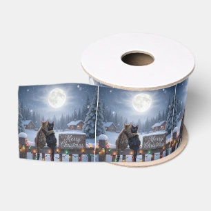 Weihnachtskatzen umarmen sich auf einem schneebede ripsband