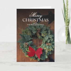 WeihnachtsKranz auf hölzerner Tür Feiertagskarte