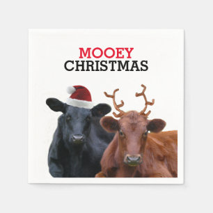Weihnachtskühe, die Weihnachtsmannmütze und Serviette