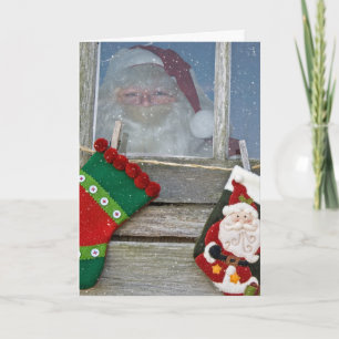Weihnachtsmann im Kabinenfenster mit Schneeflocken Karte
