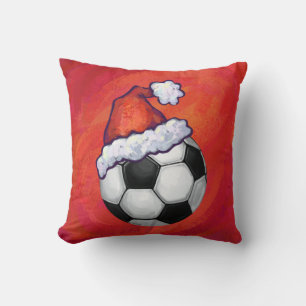 Weihnachtsmannmütze Fußball auf Rot Kissen