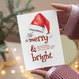 Weihnachtsmannmütze und Schneeflocken, fröhlich un Feiertagskarte