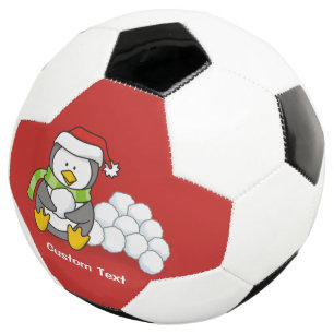 Weihnachtspinguin sitzend mit Schneebälle Fußball