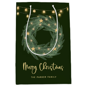 Weihnachtsreich mit goldenen String-Leuchten auf G Mittlere Geschenktüte