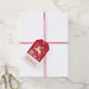 Weihnachtsren, das über Geschenkrotumbau tänzelt Geschenkanhänger