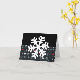 Weihnachtsschneeflocken und Blätter mit schwarzer Karte