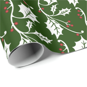Weihnachtsstechpalme auf dunkelgrünem geschenkpapier