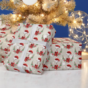 Weihnachtsziege Kind 2 in Weihnachtsmannmütze und  Geschenkpapier