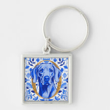 Weimaraner peering thru the letter "O" in Gold