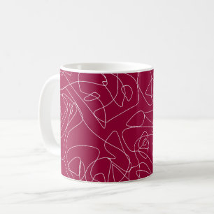 Weiße abstrakte Kritzeleien auf dunkelrotem Hinter Kaffeetasse