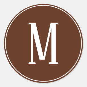Weiße Monogramm-Rundumkleber auf braunem Hintergru Runder Aufkleber