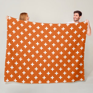 Weiße Polka-Kreuze auf verbrannter Orange Fleecedecke