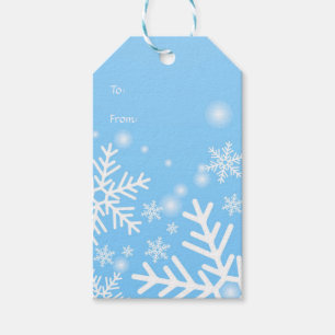 Weiße Schneeflocken auf blauen Geschenkanhänger