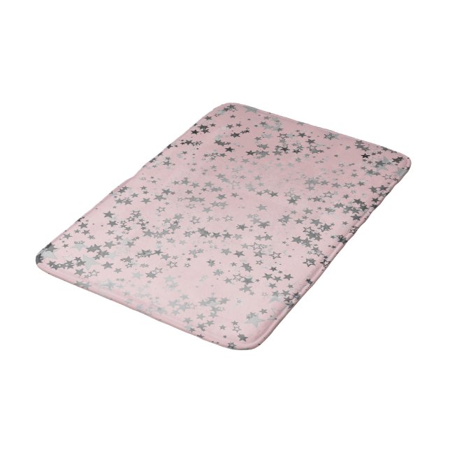 Weiße Silbersteine auf Rosa Badematte (Schrägansicht)